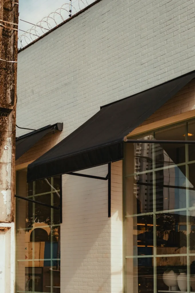 Black fabric awning on a white brick storefront