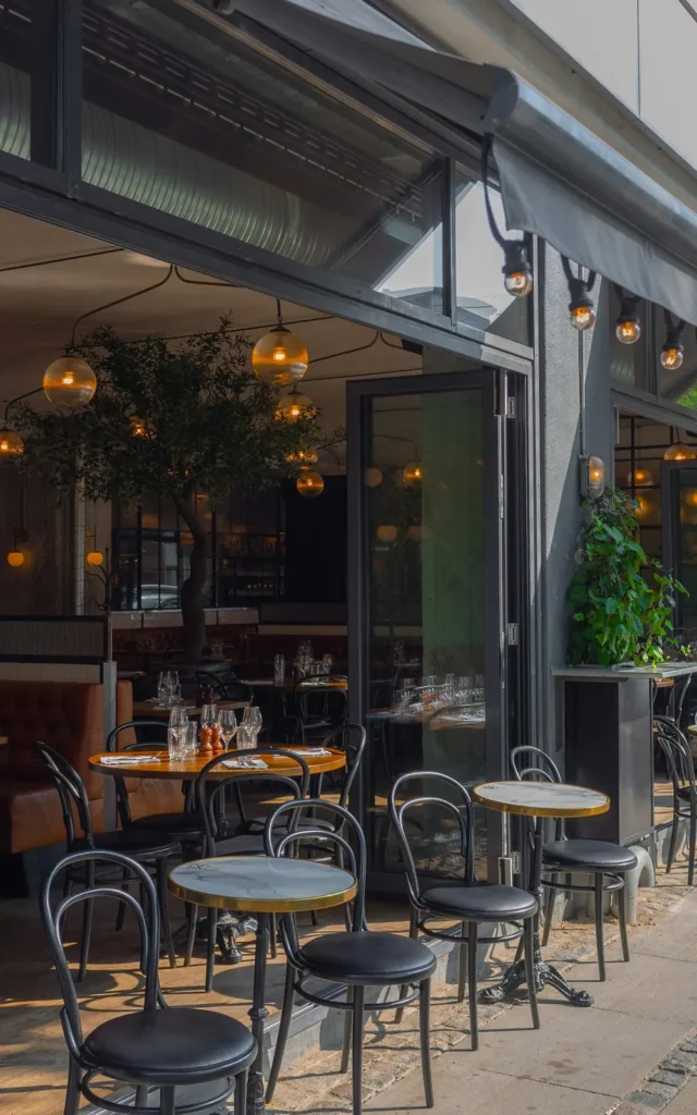 Restaurant patio under a dark storefront awning