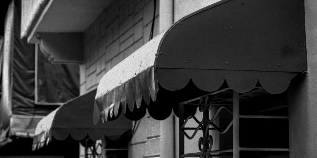 Scalloped black fabric awnings